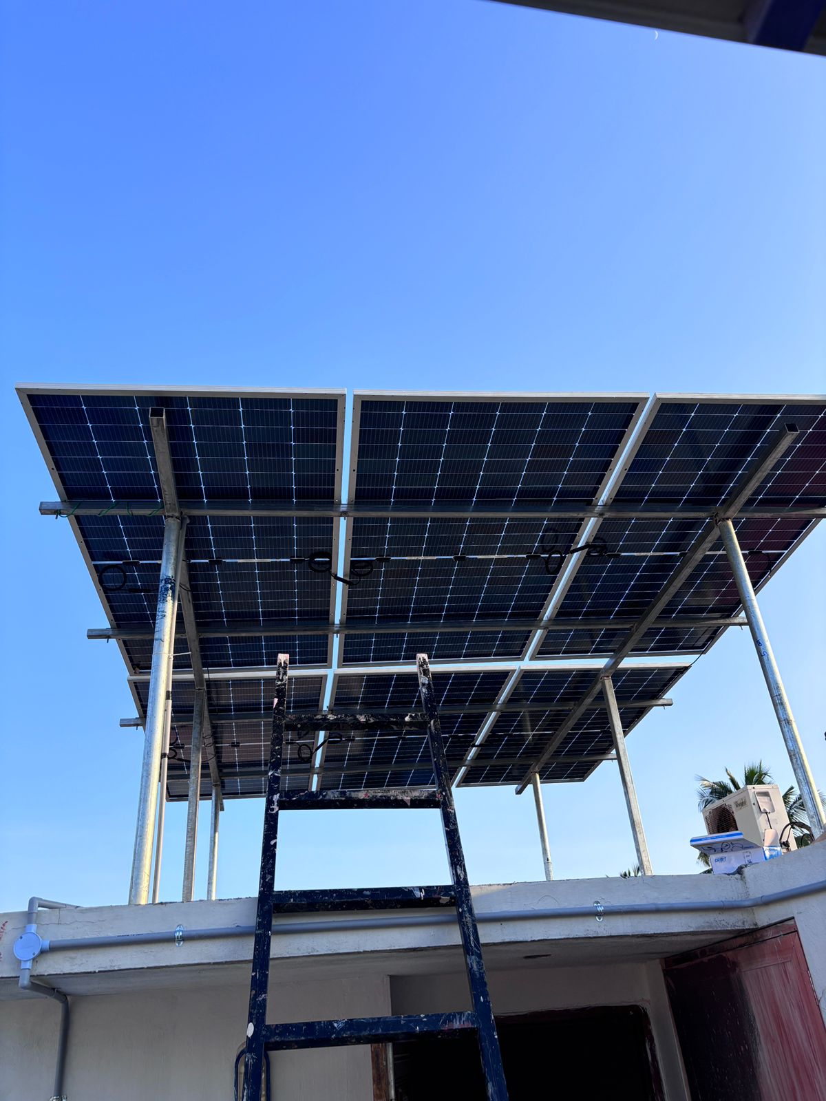 Professional solar panel installation team working on a home
